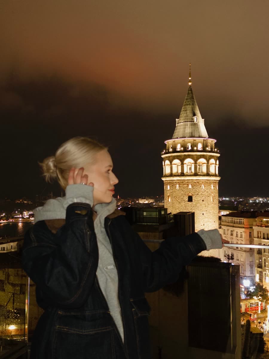 Kate with Galata Tower at night